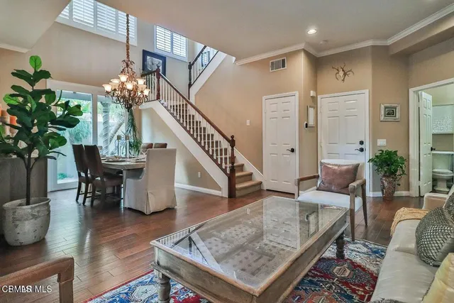 a living room with furniture and a chandelier