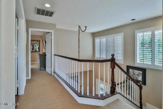 a view of a hallway with window and stairs