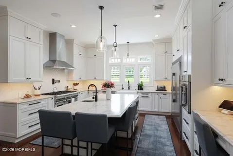 a kitchen with a faucet a stove and cabinets