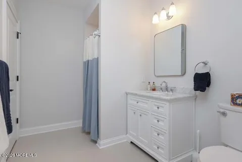 a bedroom with a bed and a television