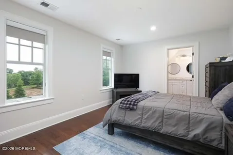 a bathroom with a granite countertop sink a mirror and shower