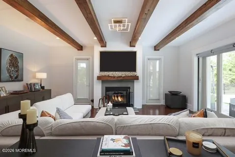 a dining room with furniture a chandelier and window