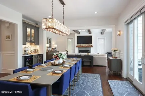 a view of a dining room and hall with furniture