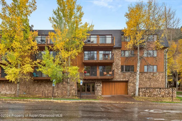 a front view of a building with a garden
