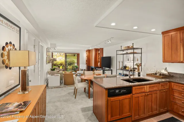 a large kitchen with a large counter top furniture appliances and a window