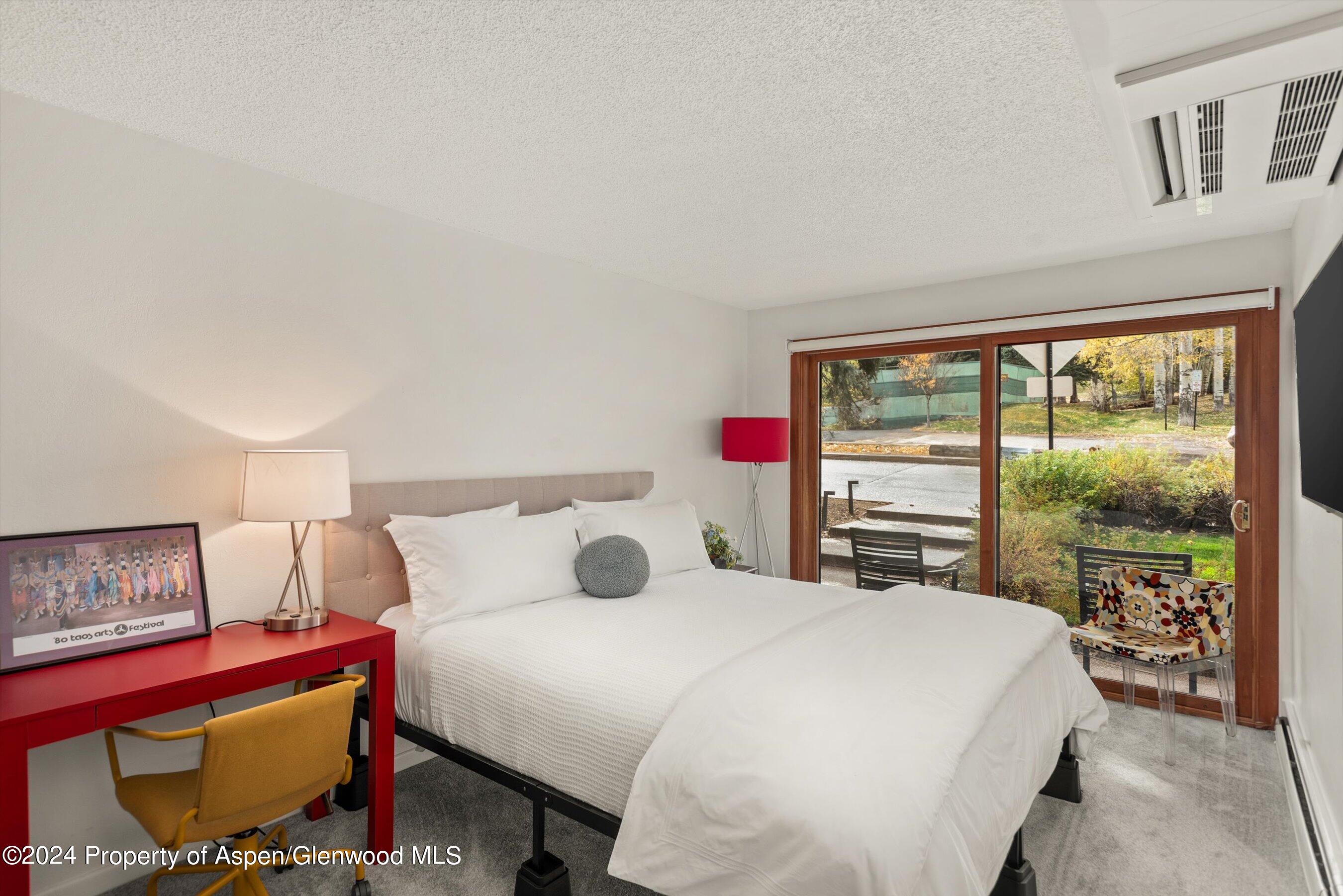 205 East Durant Avenue, Unit 1C Aspen, CO 81611 - Photo 7 of 12 a bedroom with a bed and large window