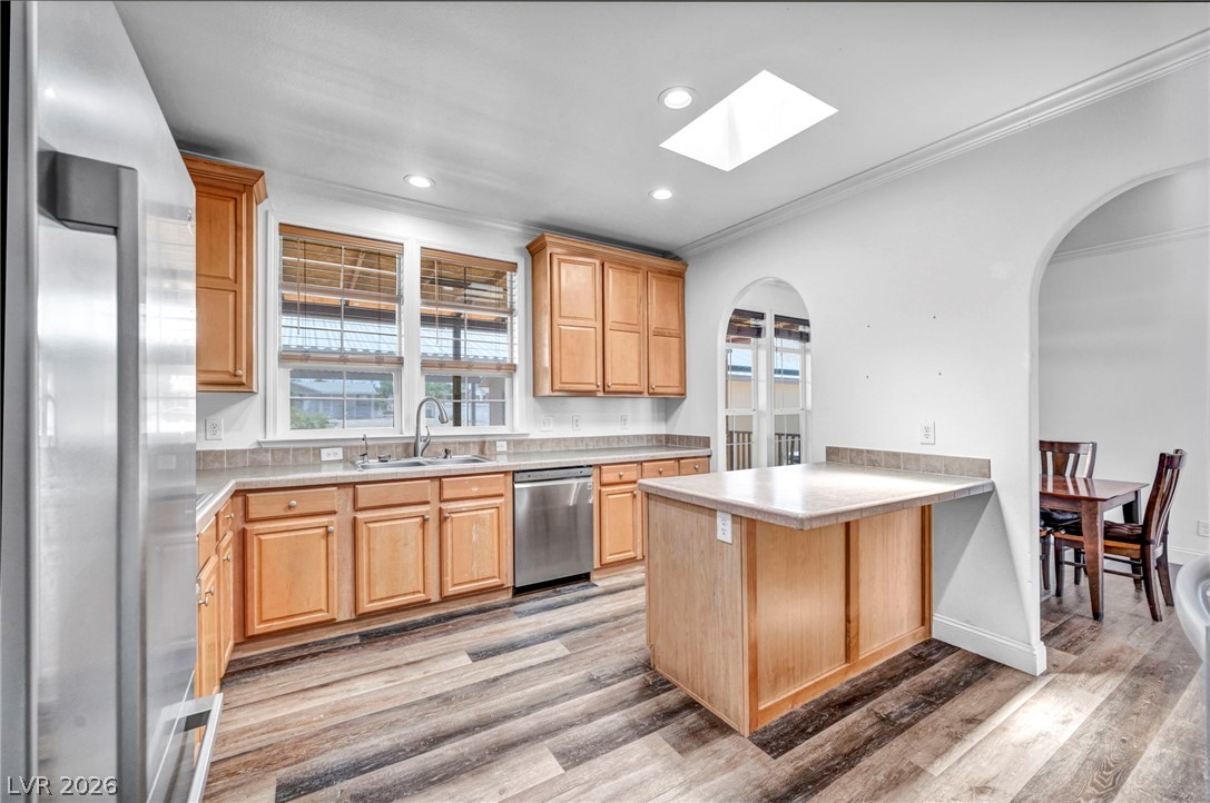 225 California Street Searchlight, NV 89046 - Photo 23 of 64 Bright, inviting kitchen space with warm wood cabinetry, modern stainless steel appliances, and a convenient kitchen island.