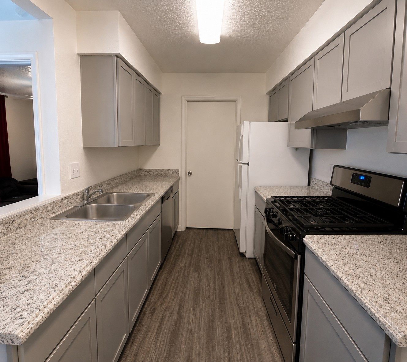 2013 Margalene Way Austin, TX 78728 - Photo 9 of 19 A galley kitchen showcasing modern appliances and ample counter space for culinary pursuits.