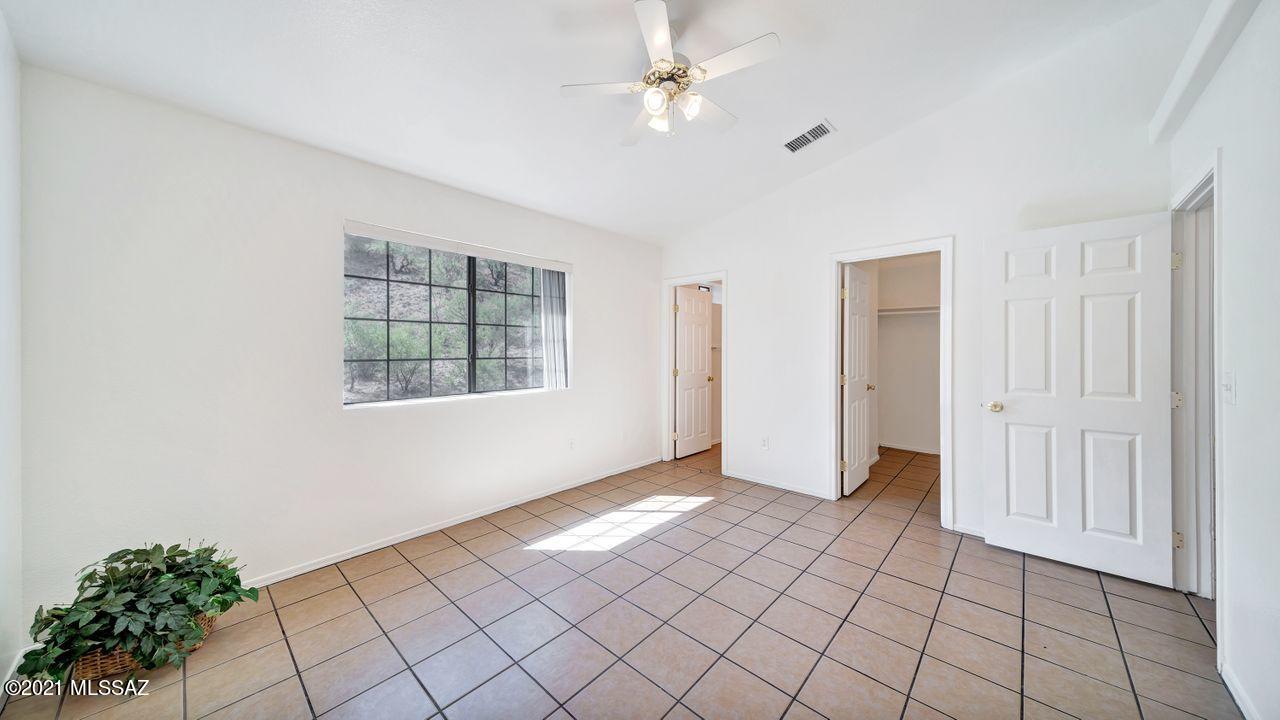 999 Circulo Golondrina Rio Rico, AZ 85648 - Photo 17 of 36 an empty room with windows and ceiling fan