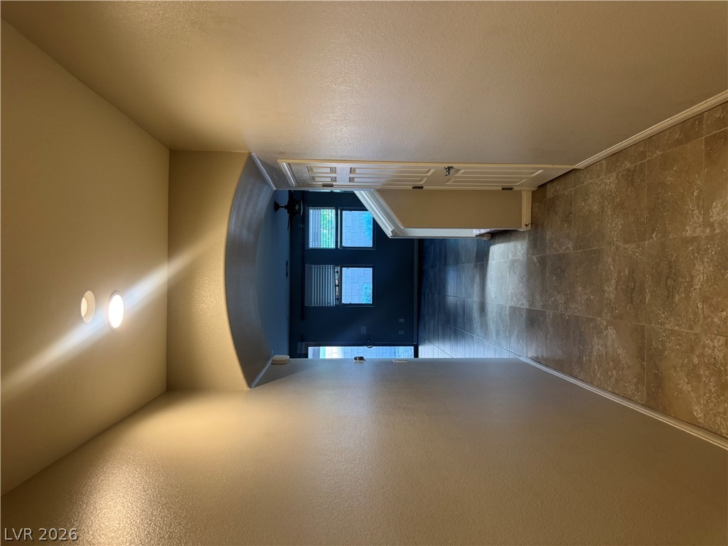 55 Canopus Ridge Way Las Vegas, NV 89183 - Photo 15 of 53 An arched entryway and tile flooring connect the transition spaces of this home.