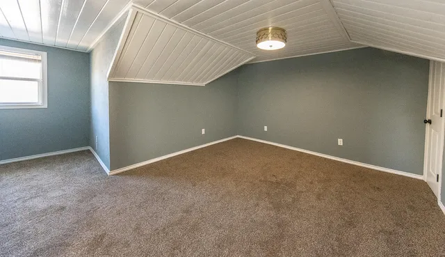 a view of a house with a yard and garage