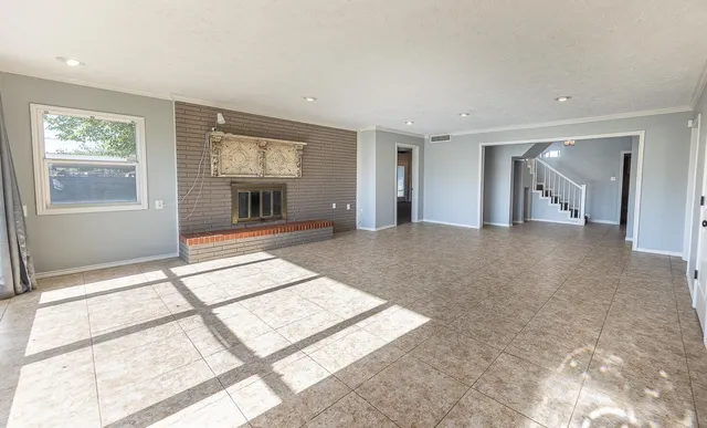 a view of a big room with windows and entryway