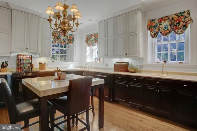 a dining table with chairs and window