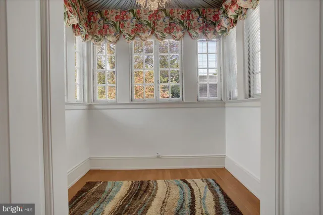 a bedroom with a bed a dresser and a window