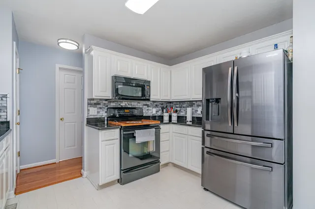 a kitchen with stainless steel appliances and refrigerator