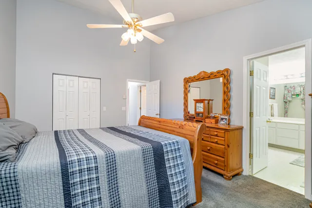 a bedroom with bed and wooden floor