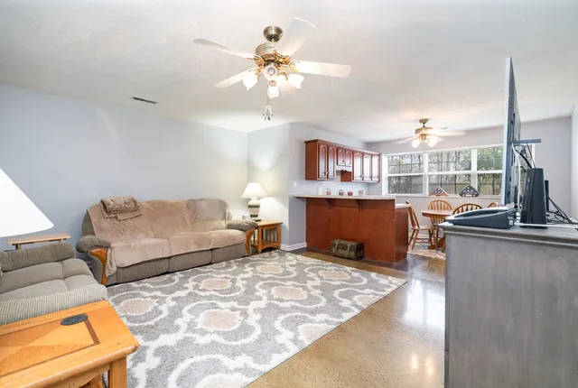 a living room with furniture and a chandelier