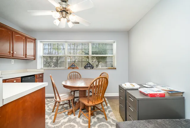 a view of a dining room with furniture and chandelier