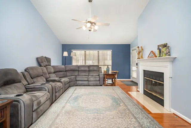 a living room with furniture and a fireplace