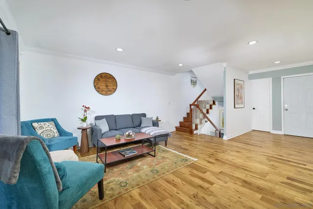 a living room with furniture and white walls