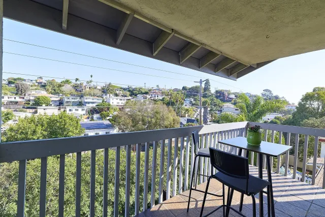 a view of a balcony with chairs