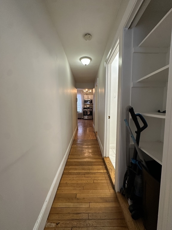 47 Wallingford Road, Unit 1 Boston, MA 02135 - Photo 12 of 16 a view of a hallway with wooden floor and stairs