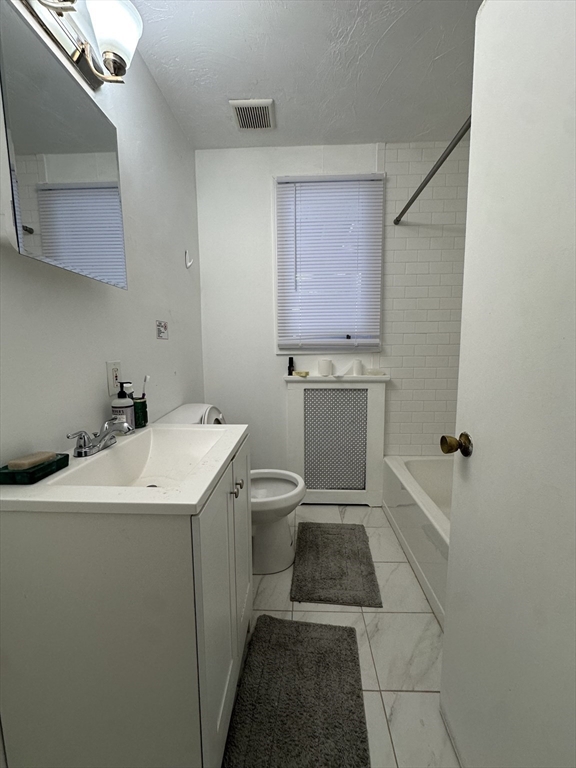 47 Wallingford Road, Unit 1 Boston, MA 02135 - Photo 16 of 16 a utility room with a sink washer and dryer