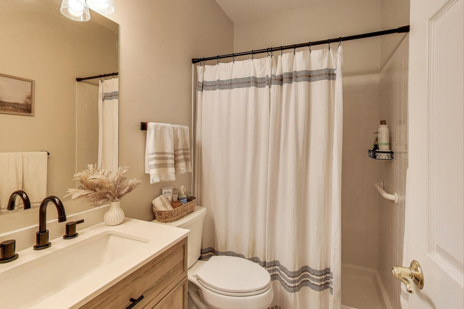 1010 Evergreen Street Mundelein, IL 60060 - Photo 12 of 28 a bathroom with a sink a toilet and shower