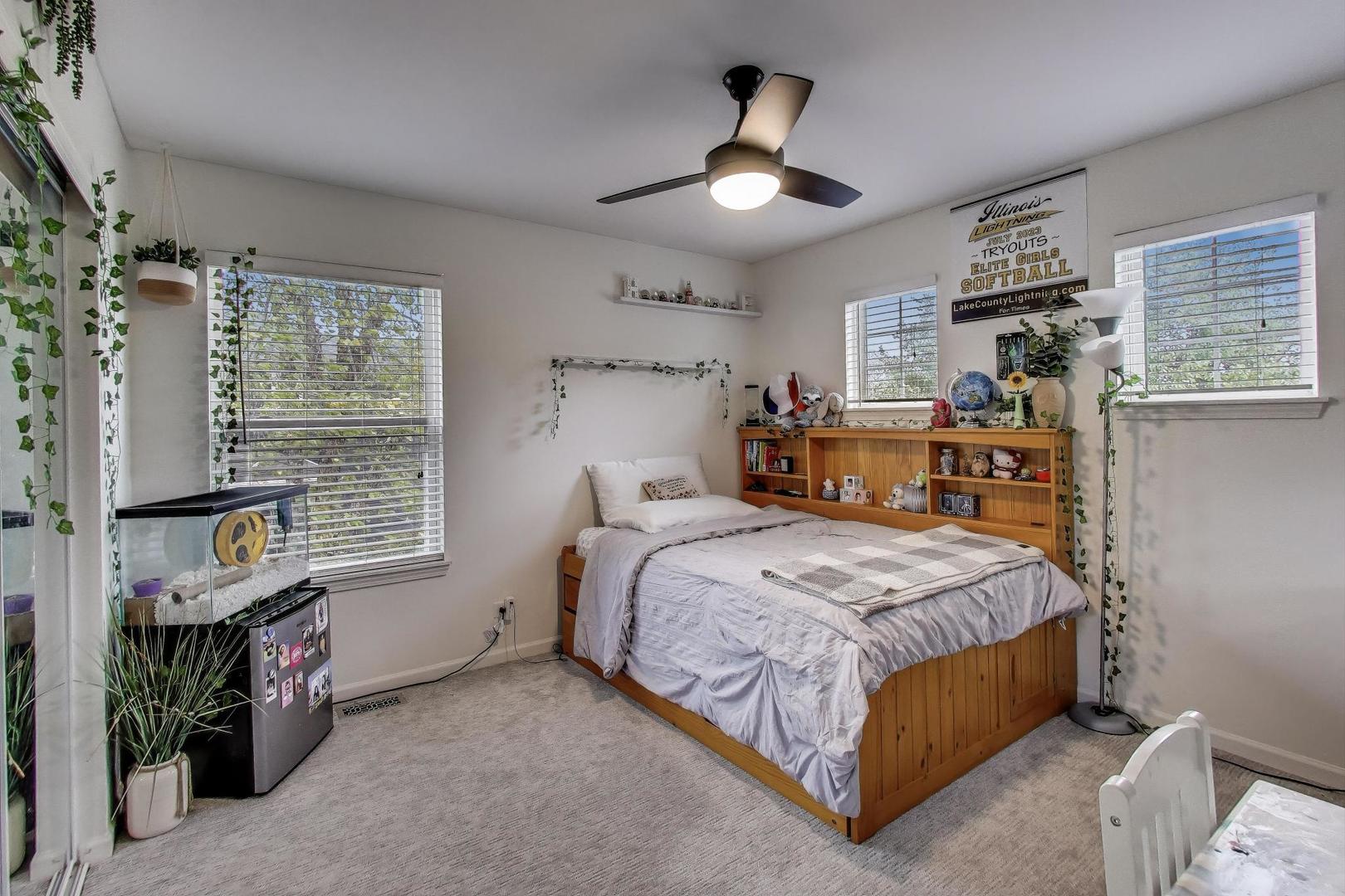 1010 Evergreen Street Mundelein, IL 60060 - Photo 19 of 28 a bedroom with a bed chandelier and a window
