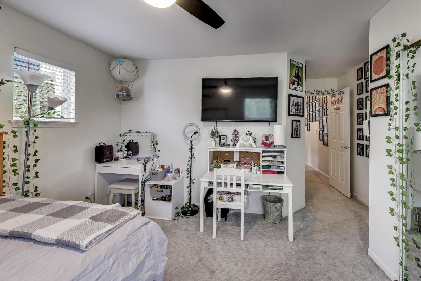 1010 Evergreen Street Mundelein, IL 60060 - Photo 20 of 28 a bedroom with a bed and a flat screen tv