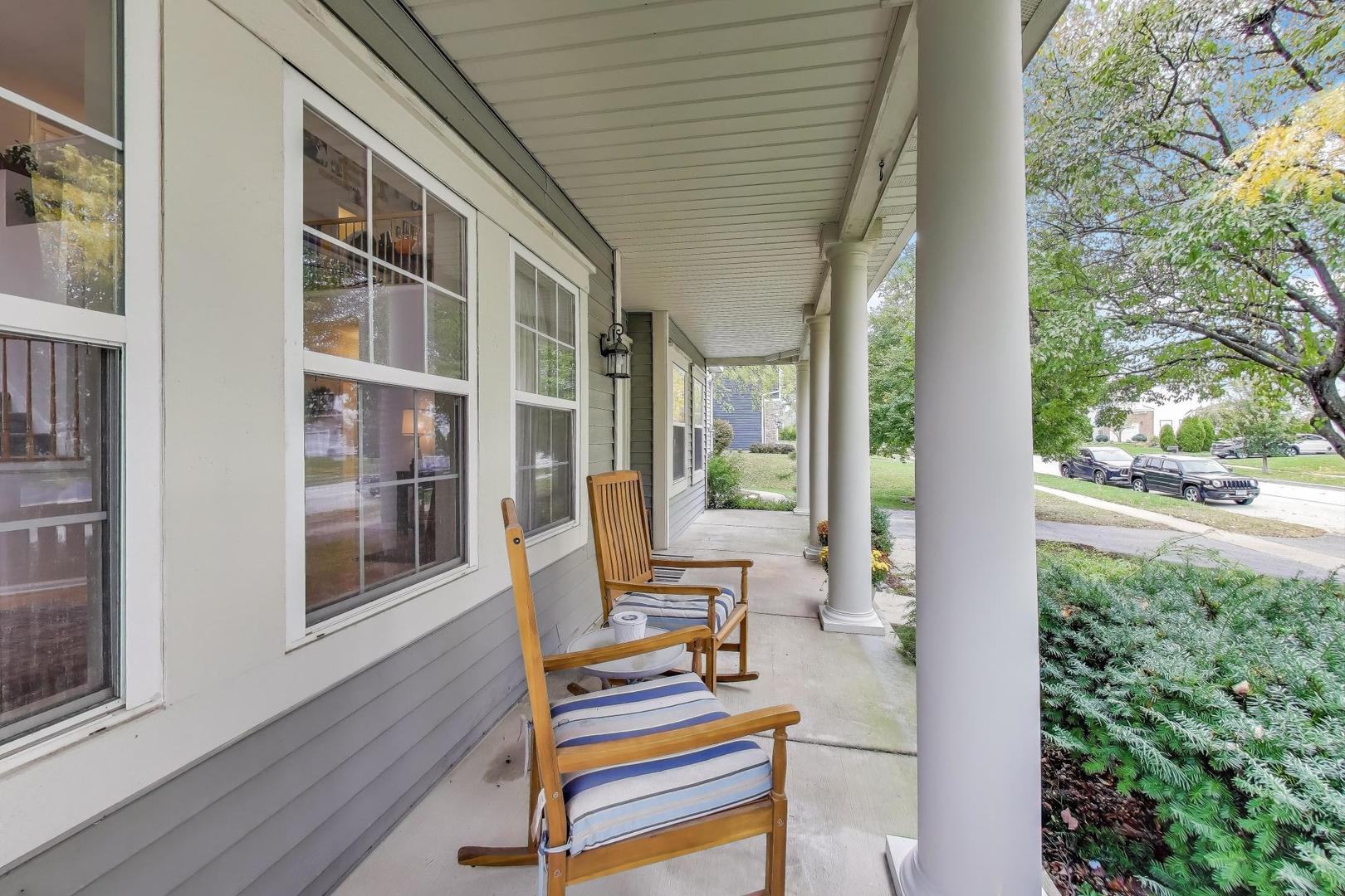 1010 Evergreen Street Mundelein, IL 60060 - Photo 2 of 28 a view of balcony with two chairs and a potted plant