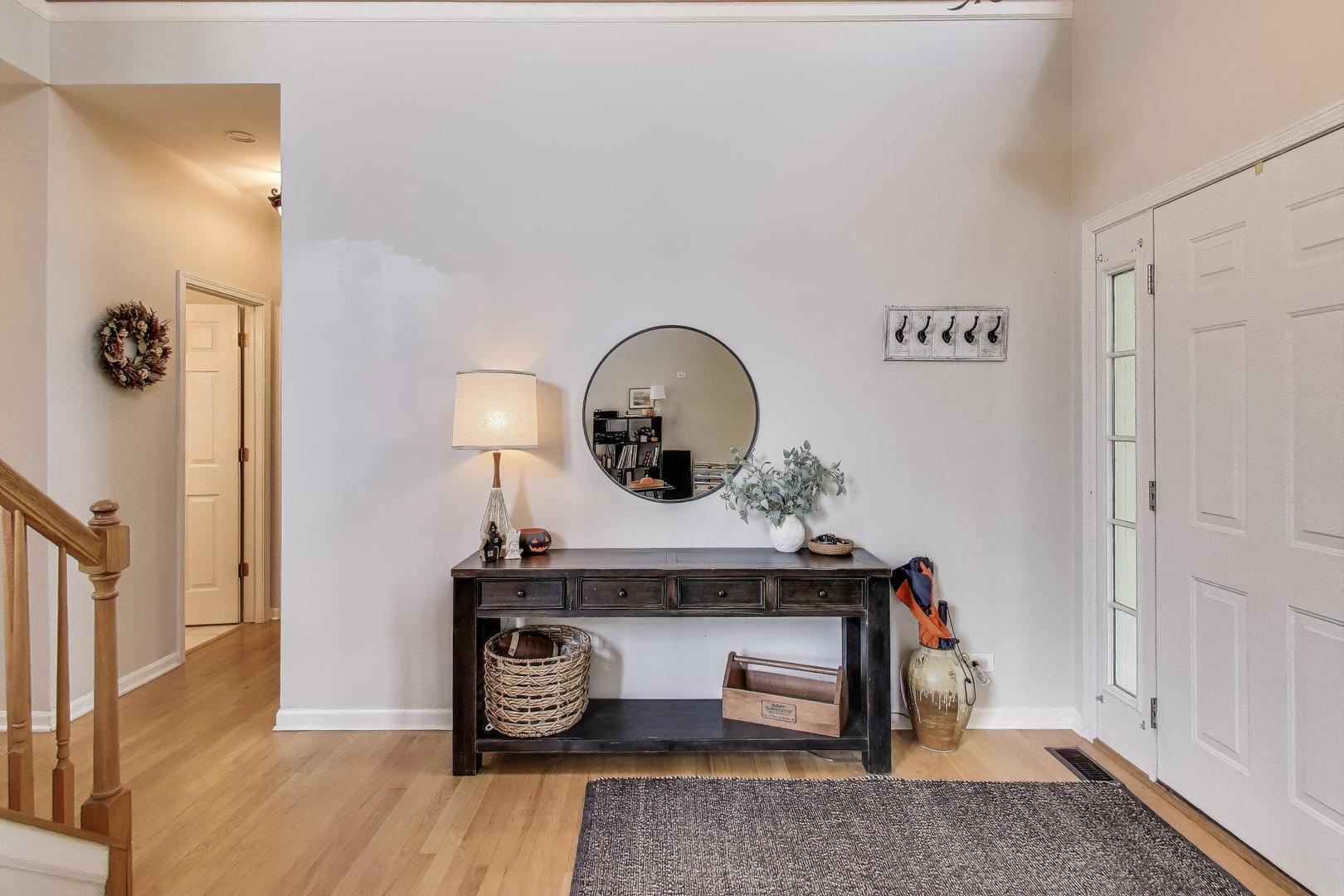 1010 Evergreen Street Mundelein, IL 60060 - Photo 3 of 28 a view of a hallway with entryway wooden floor and front door