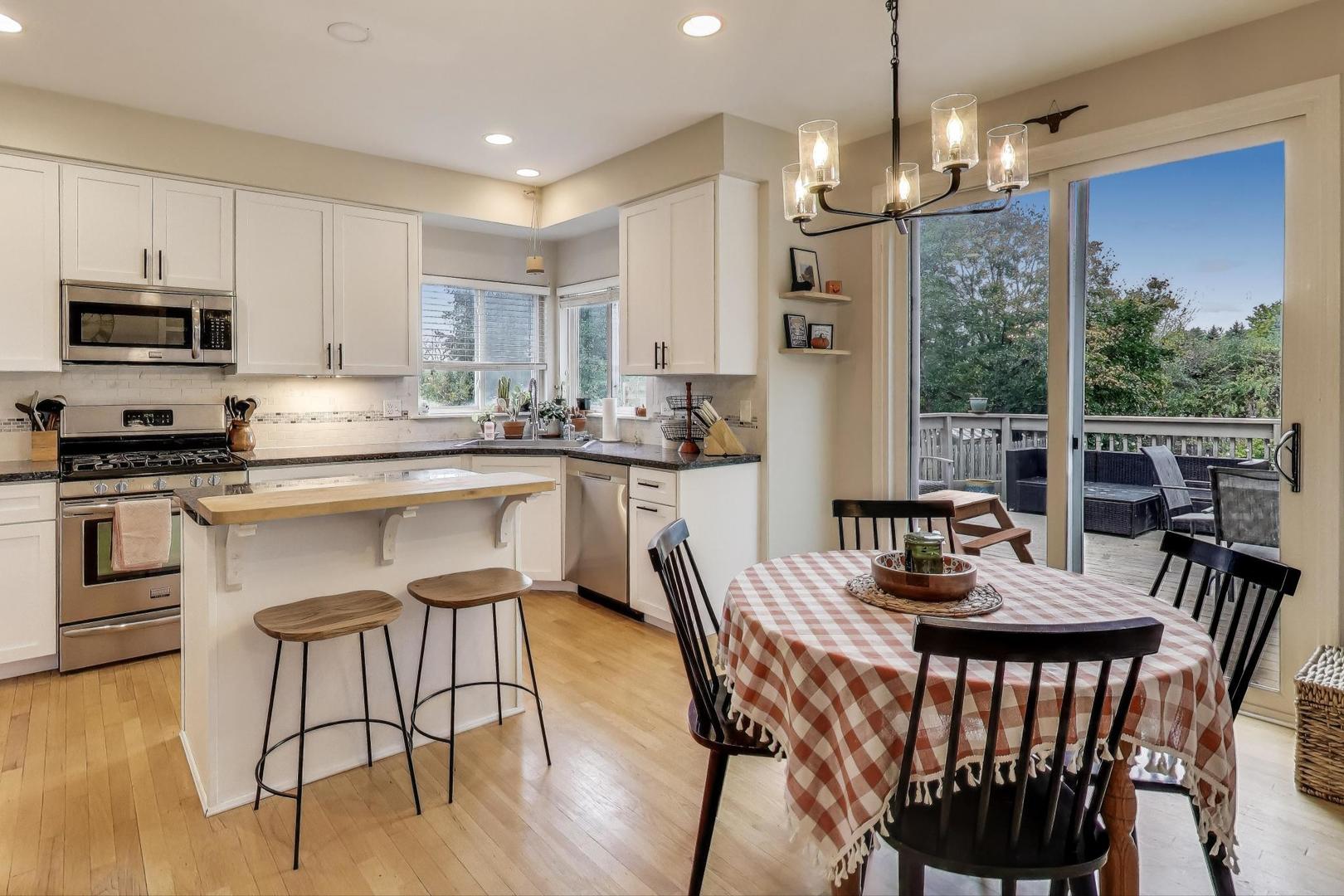 1010 Evergreen Street Mundelein, IL 60060 - Photo 7 of 28 a kitchen with stainless steel appliances granite countertop a kitchen island a stove a table and chairs