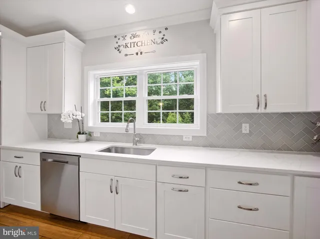 a kitchen with a sink and cabinets