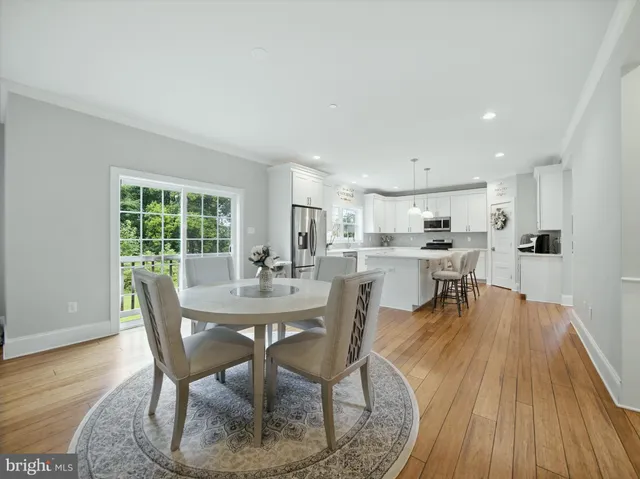 a dining room with furniture and wooden floor