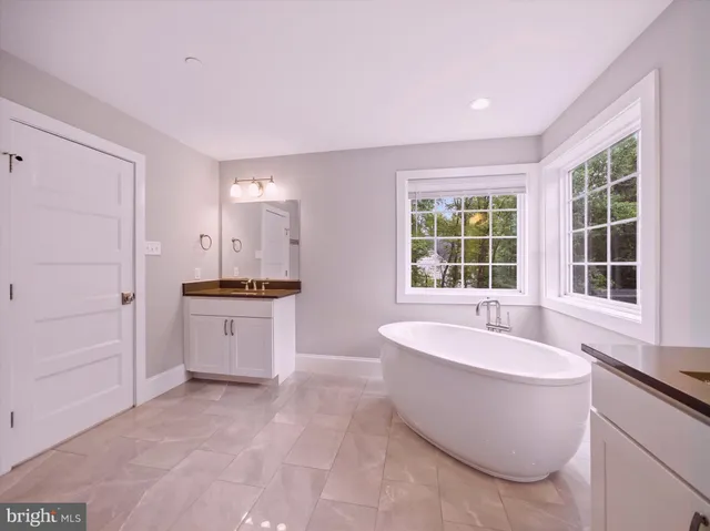 a large spacious bathroom with a large tub shower and sink