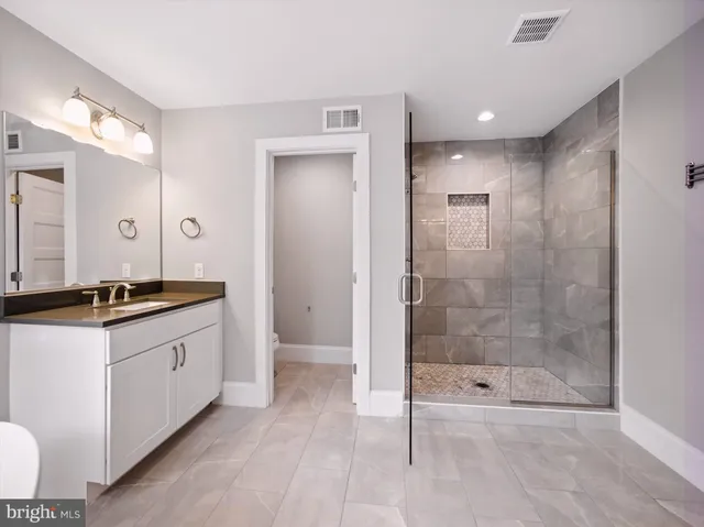 a bathroom with a sink a mirror and a shower