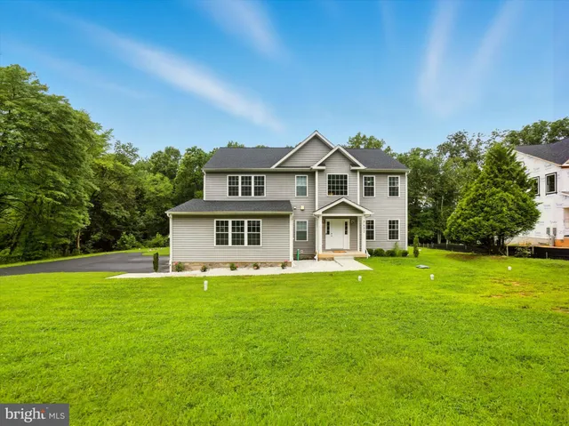 a front view of a house with a yard table and chairs