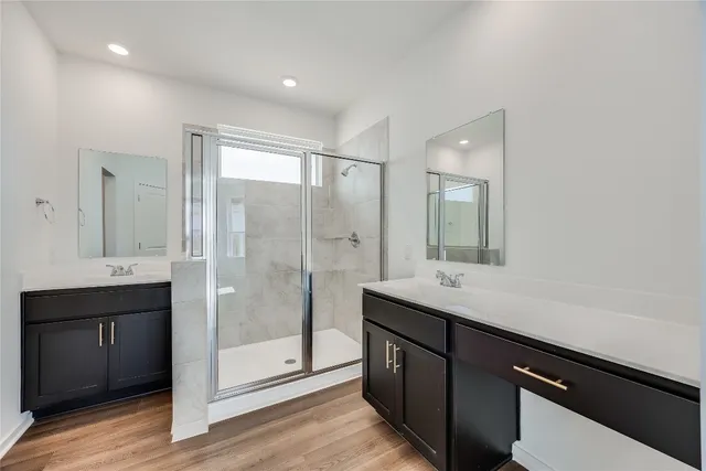 a bathroom with a shower sink and mirror