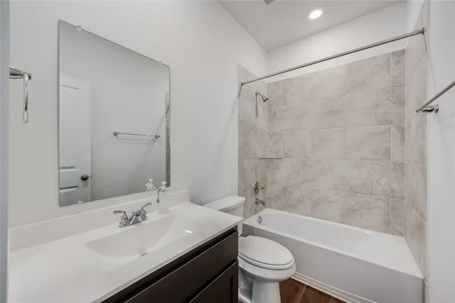 a bathroom with a sink toilet tub and shower