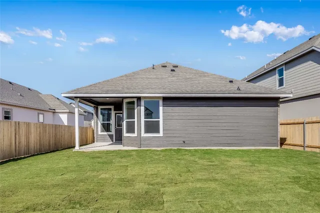 a view of a house with a backyard