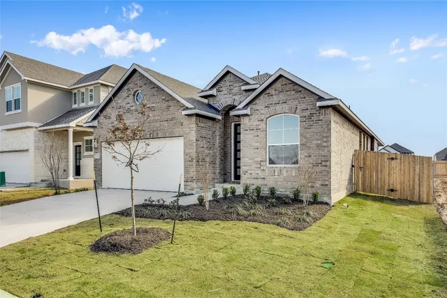 a view of a house with wooden fence