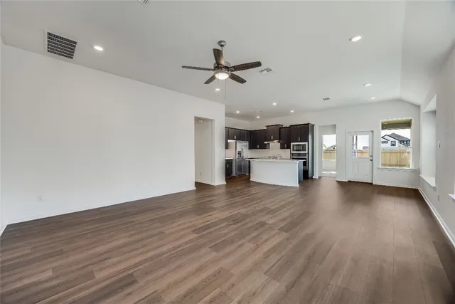 a view of a kitchen with a sink and a refrigerator