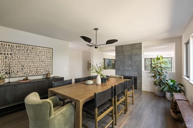 a view of a dining room with furniture window and wooden floor