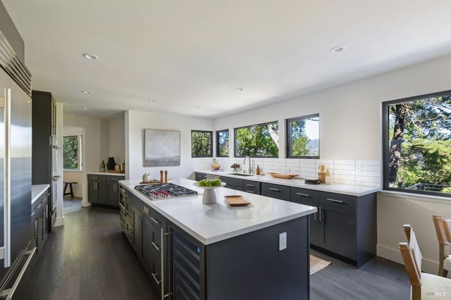 a kitchen with sink stove and cabinets