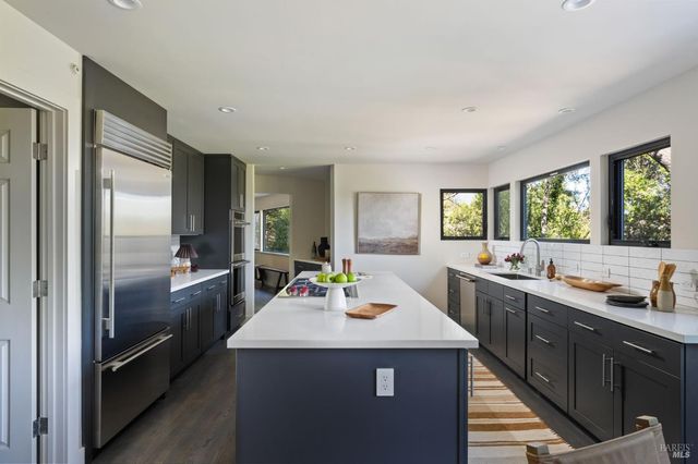 a kitchen with sink refrigerator and stove