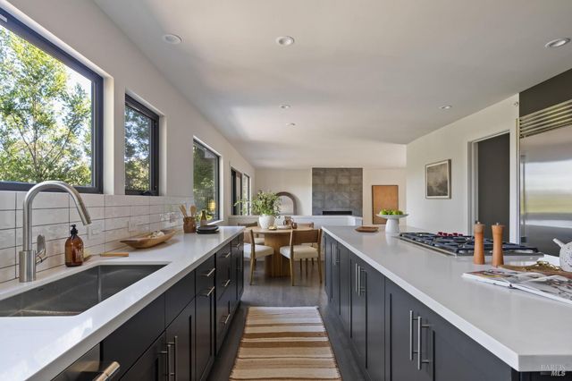 a kitchen with lots of counter space and windows