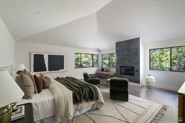 a bedroom with furniture and a fireplace