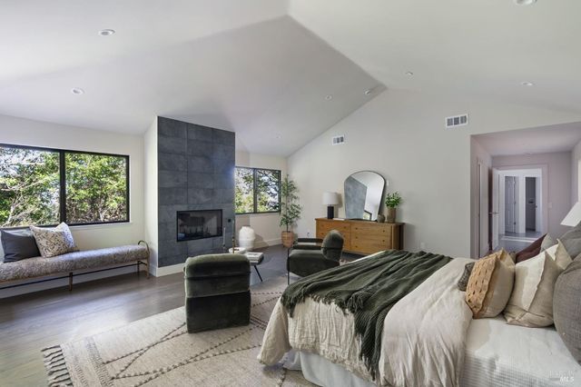 a bedroom with a bed couch and a window