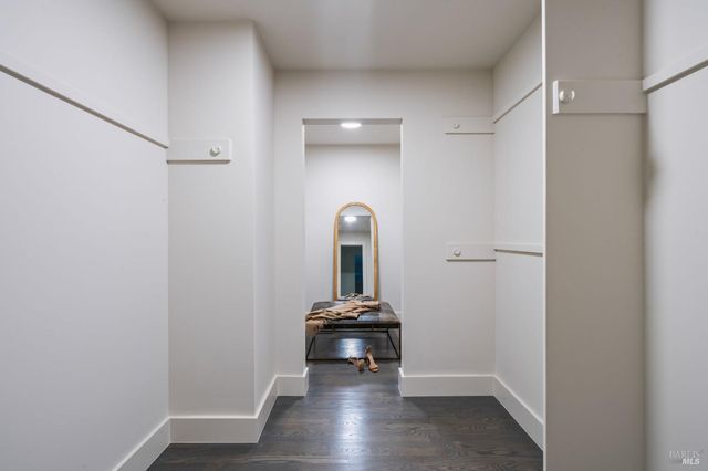 a view of a hallway with wooden floor and a sink